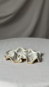 Minimalistyczna biała podstawka ceramiczna o falowanej formie